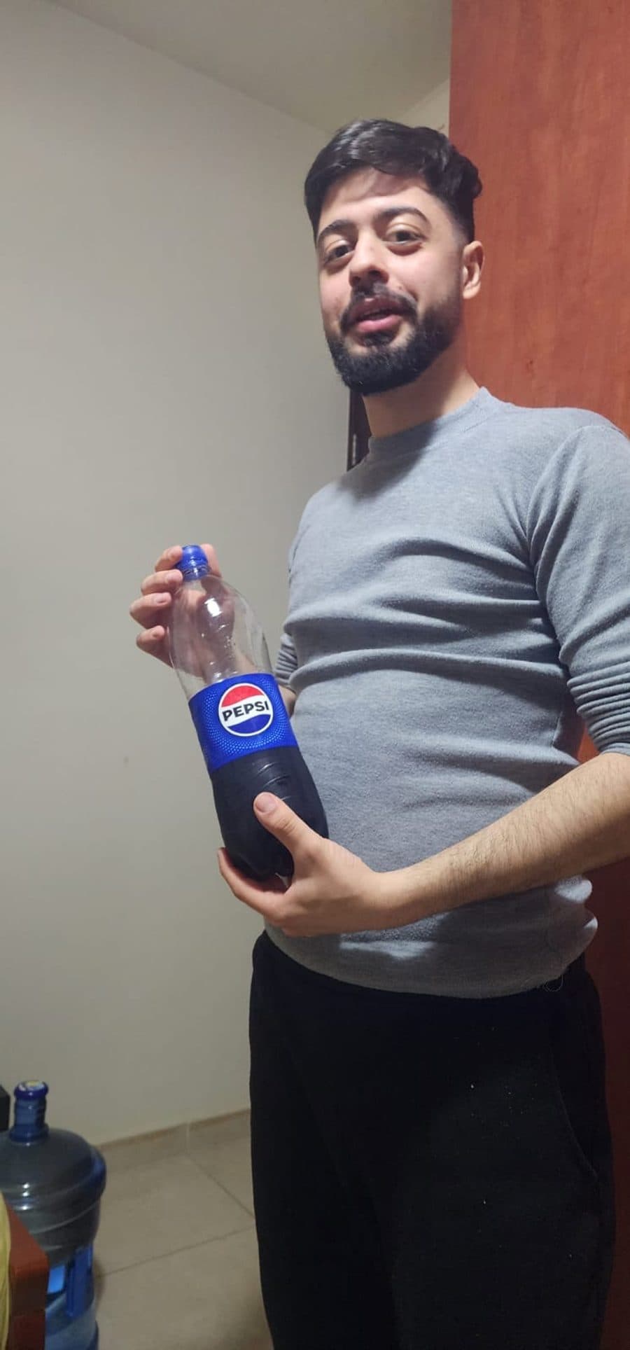 Doumit holding a large bottle of Pepsi