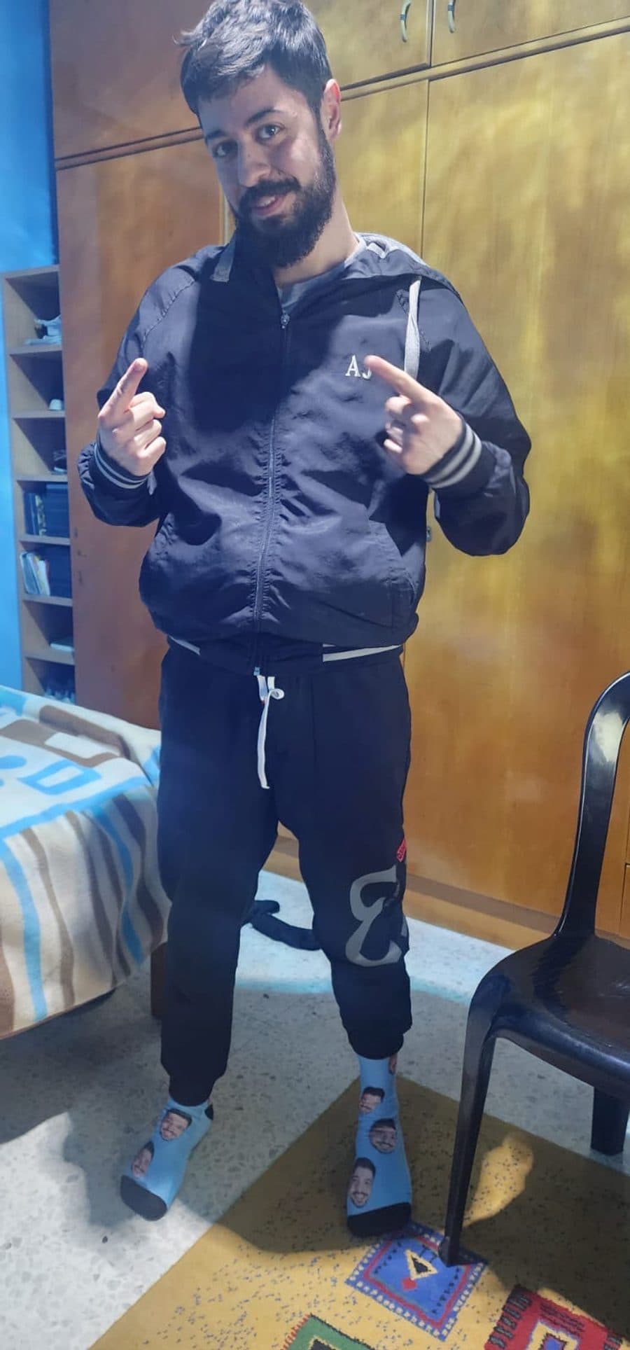 Doumit pointing at socks printed with his own face