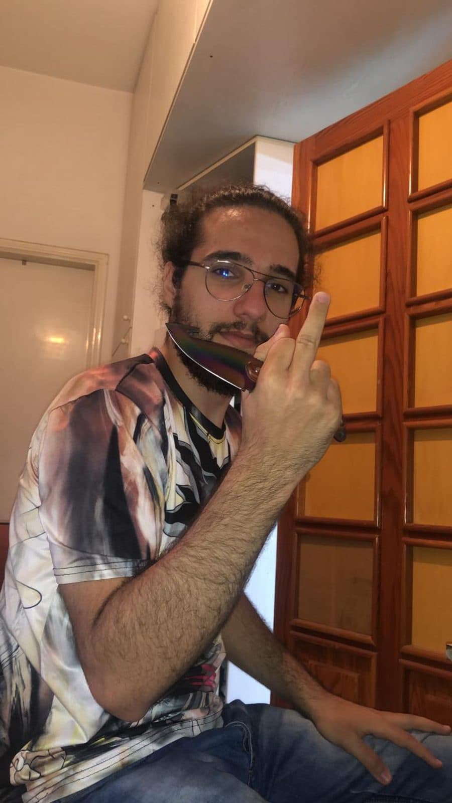 Patrick posing with a rainbow knife against his beard